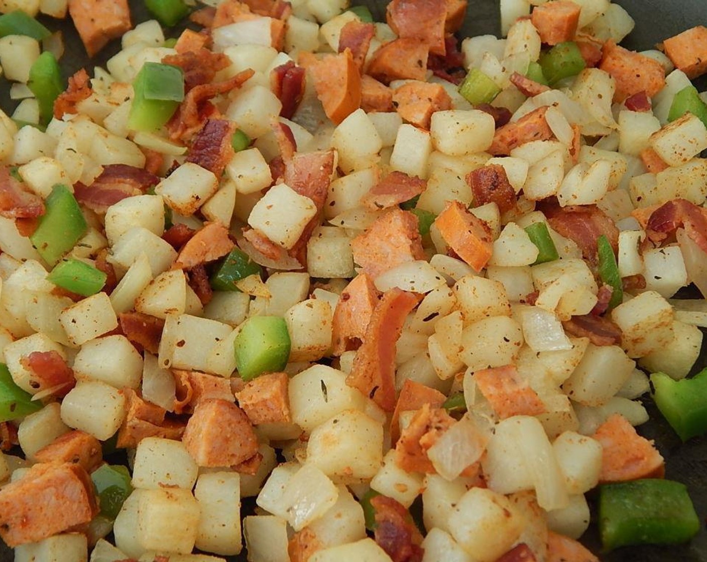 step 5 Cut up your cooked sausage into small pieces and crumble up your cooked bacon, and add to your hash brown mixture.