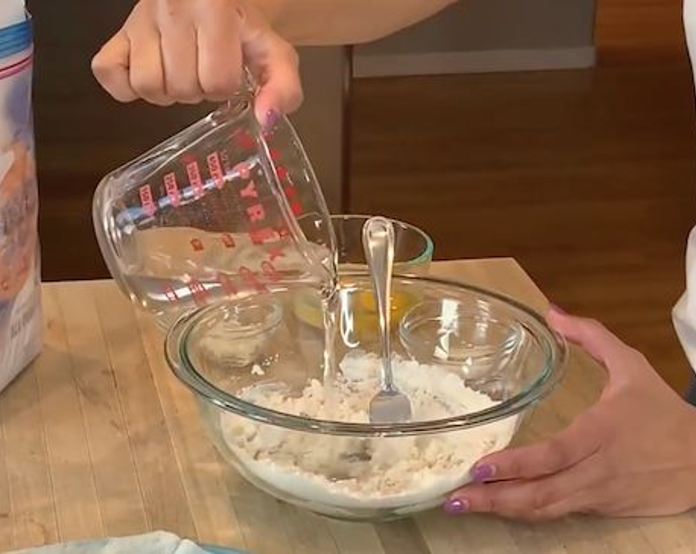 step 2 In a measuring cup set aside about 1 cup of Water (as needed). Then in a large bowl pour in All-Purpose Flour (2 cups) and slowly add water until the flour begins to thicken up, you might not need all of it.