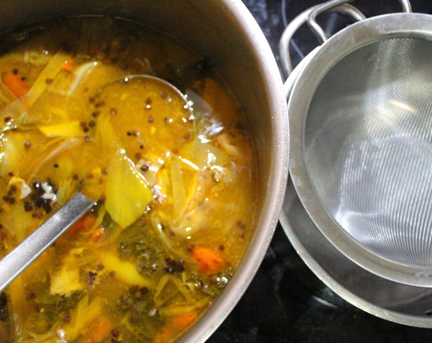 step 5 Strain the soup, discard the solids. There should be 2 quarts of soup at this point, if not, adjust by reducing or adding liquid.