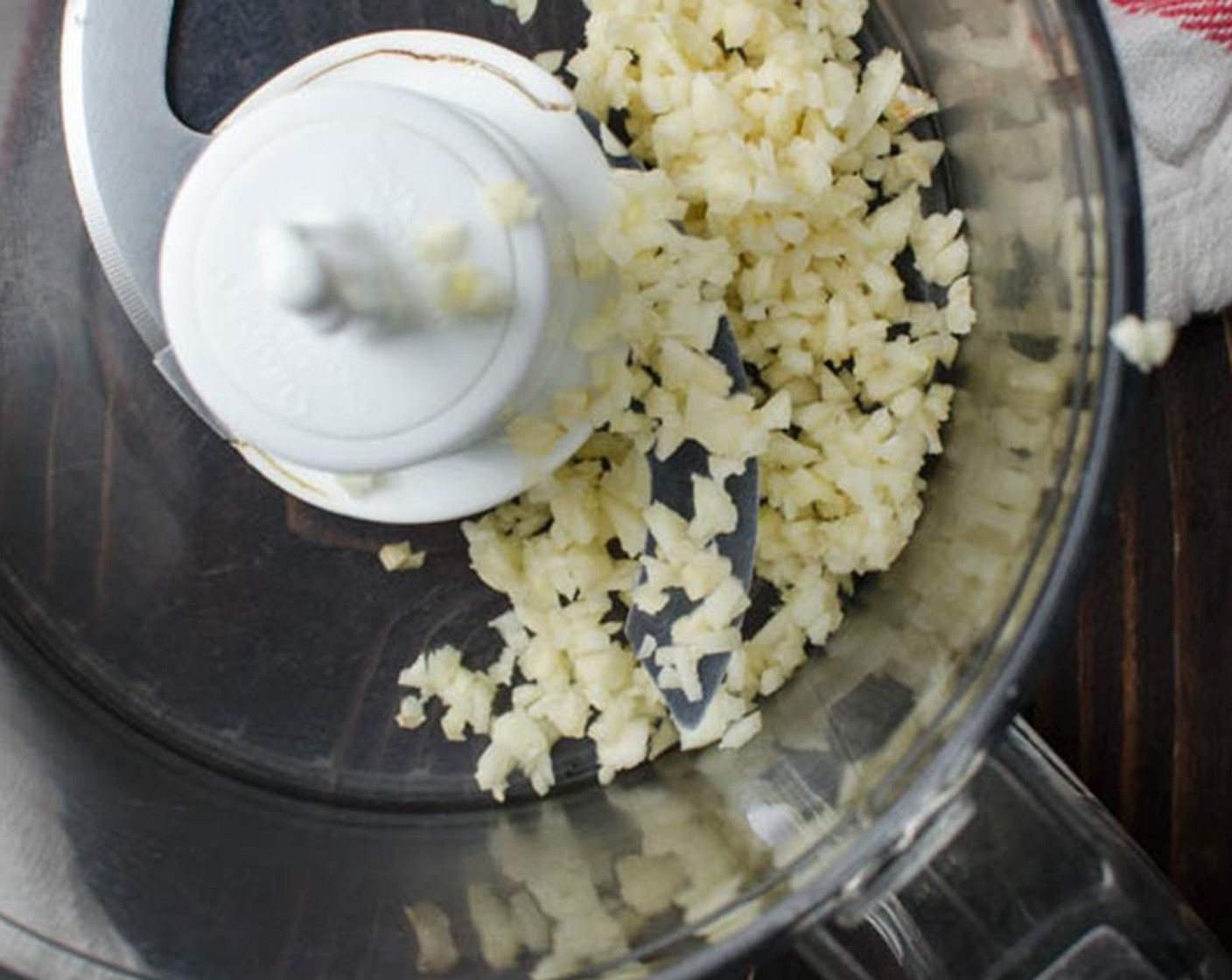 step 3 Add the Garlic (3 cloves) to a food processor and pulse until minced.
