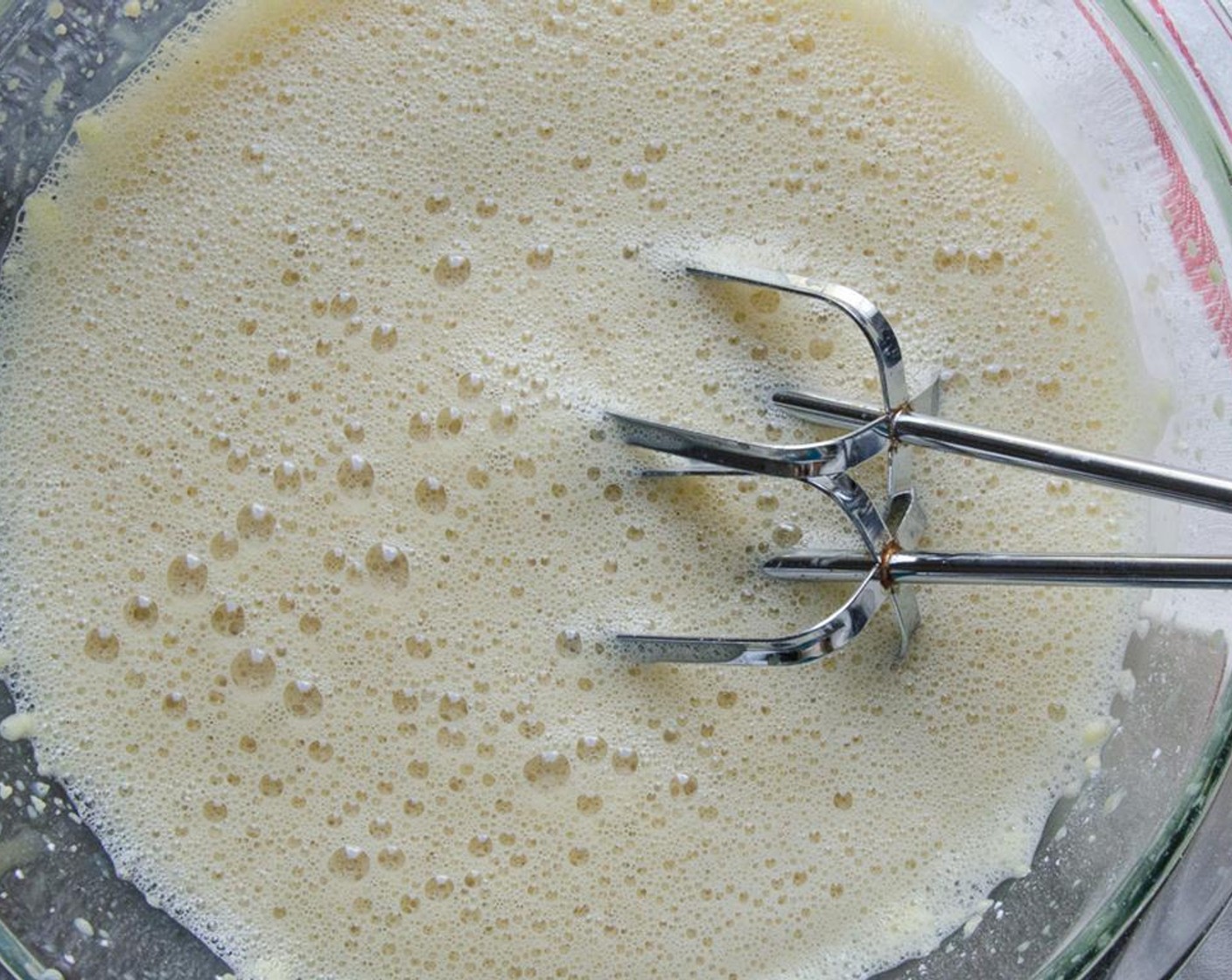 step 4 Add the milk in a steady stream to the egg mixture, beating until well combined. Pour back into the pan and heat over low heat, stirring constantly until custard begins to thicken.