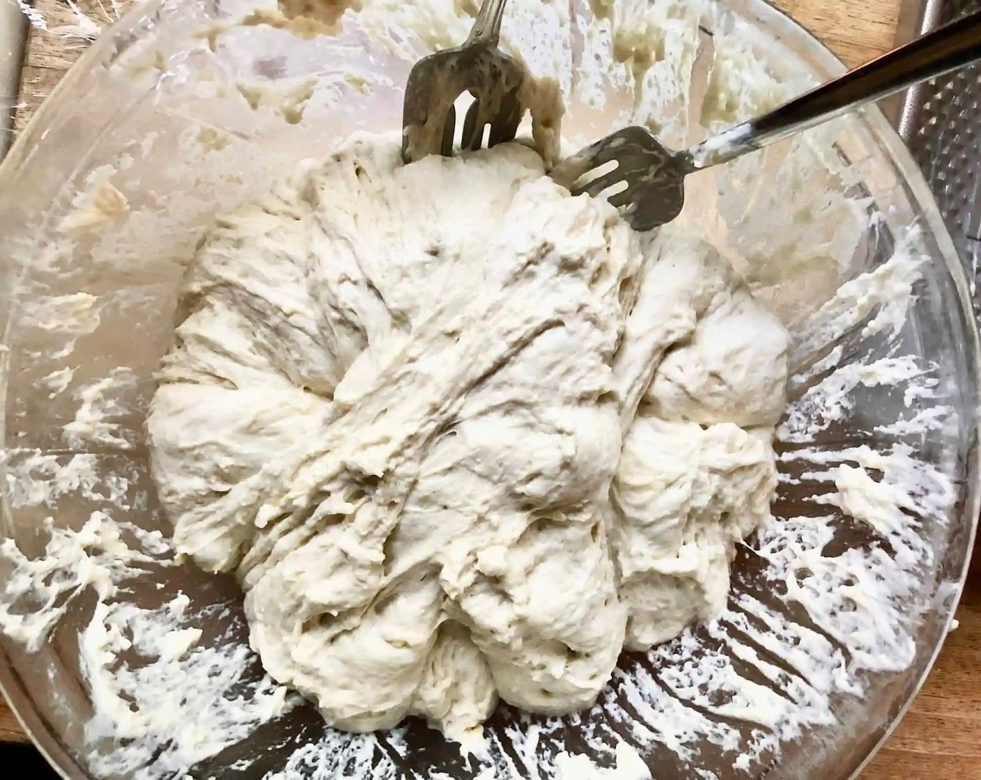 step 4 Using two forks, deflate the dough by releasing it from the sides of the bowl and pulling it toward the center. Rotate the bowl quarter turns as you deflate, turning the mass into a rough ball.