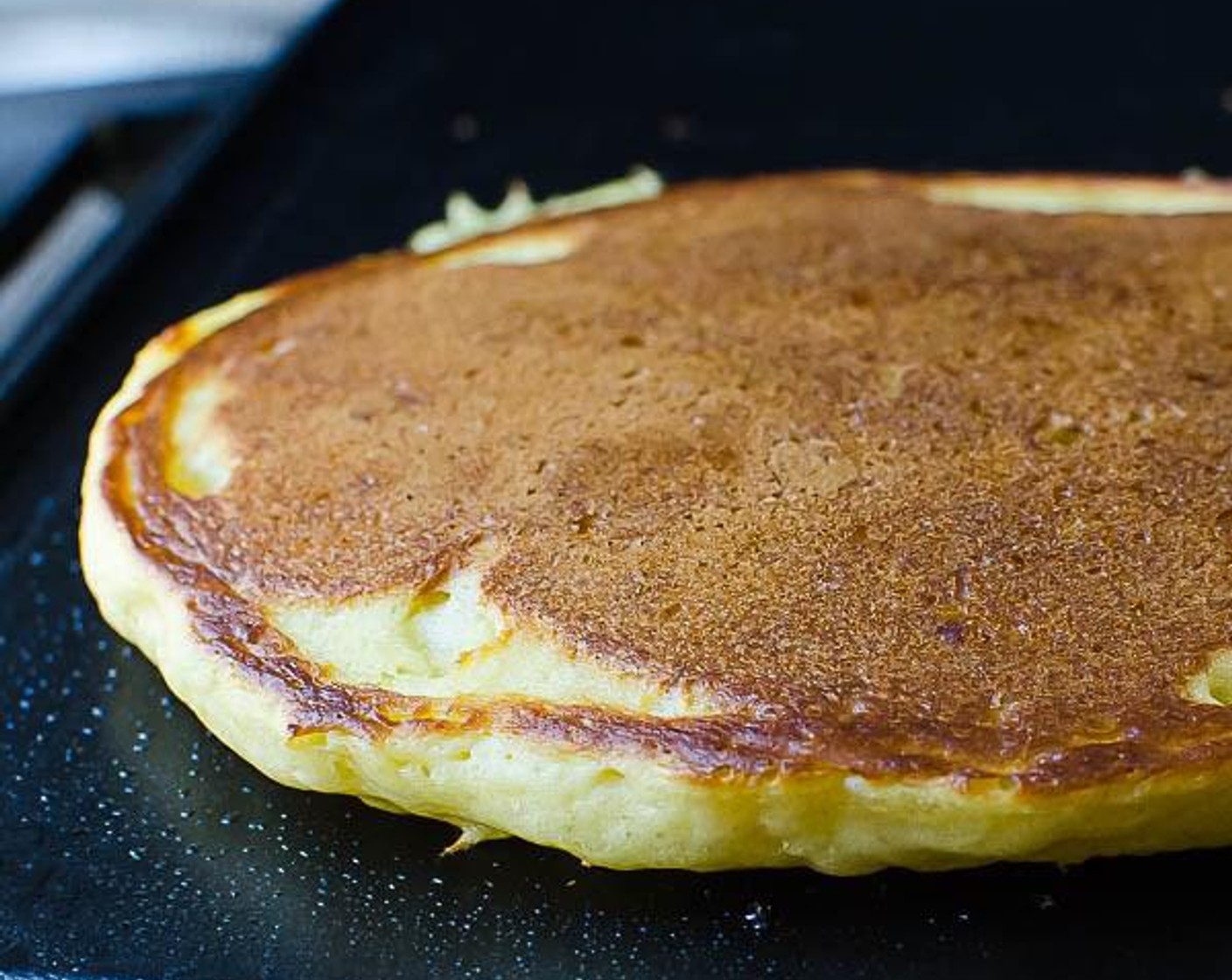 step 7 Ladle the batter onto the griddle or pan and cook for 2 to 3 minutes or until bubbles form on top and pancake starts to dry around the edges. Use a spatula to flip the pancake and continue cooking for 2 minutes or so until done.