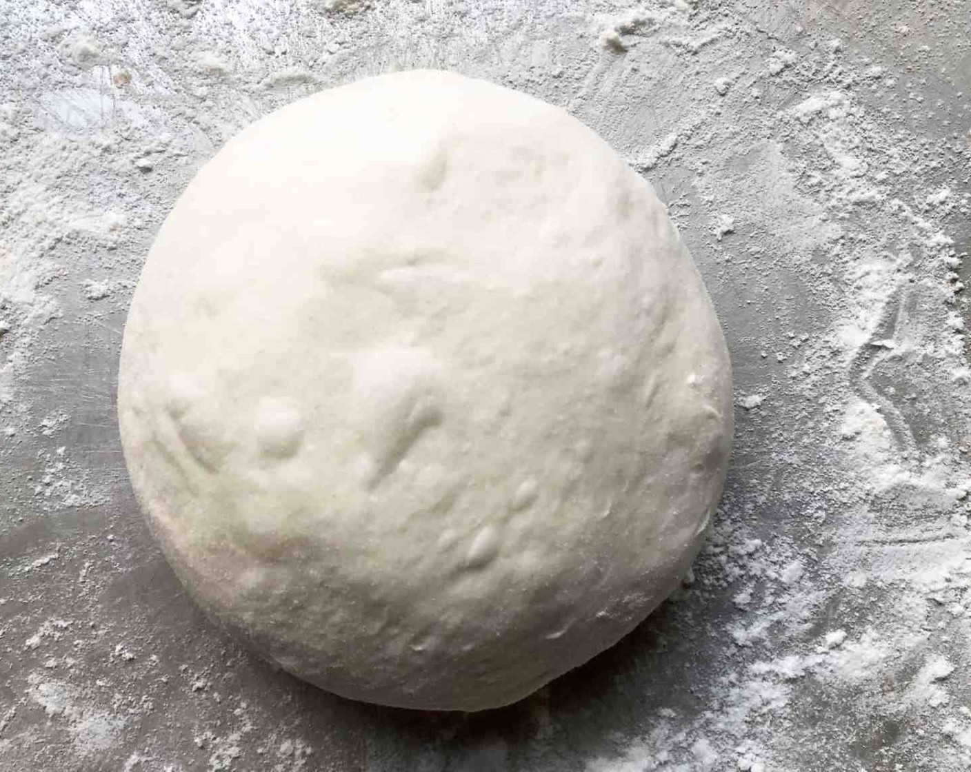 step 7 Sprinkle the surface of the refrigerated dough with flour. Pull up and cut off a piece of orange-sized dough that weighs about 8 oz. A serrated knife or kitchen shears will be helpful.