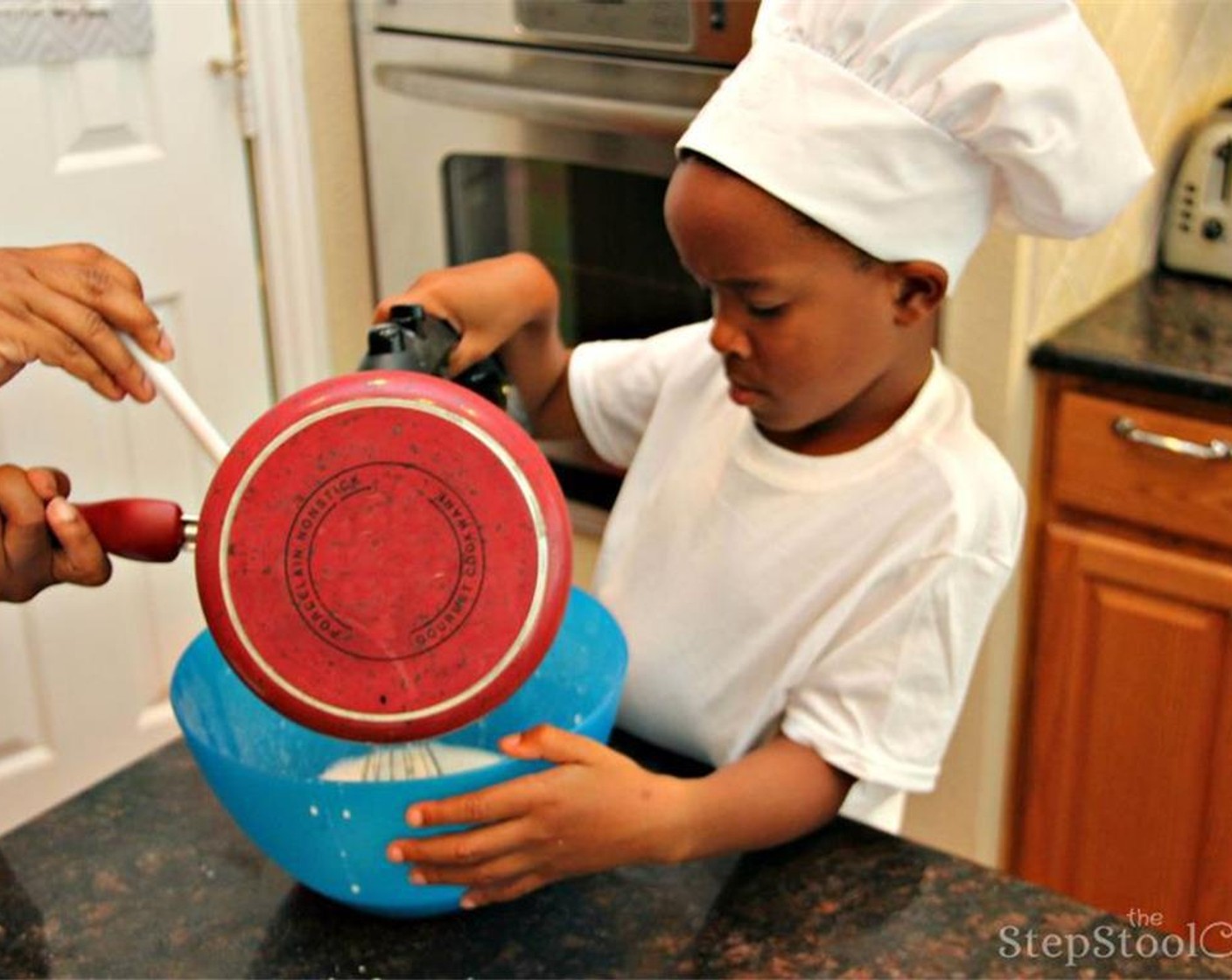 step 6 Then you add the hot milk to the batter.  Here, the Sous Chef or adult helper should help with the hot milk as the little chef slowly whisks the milk into the batter.