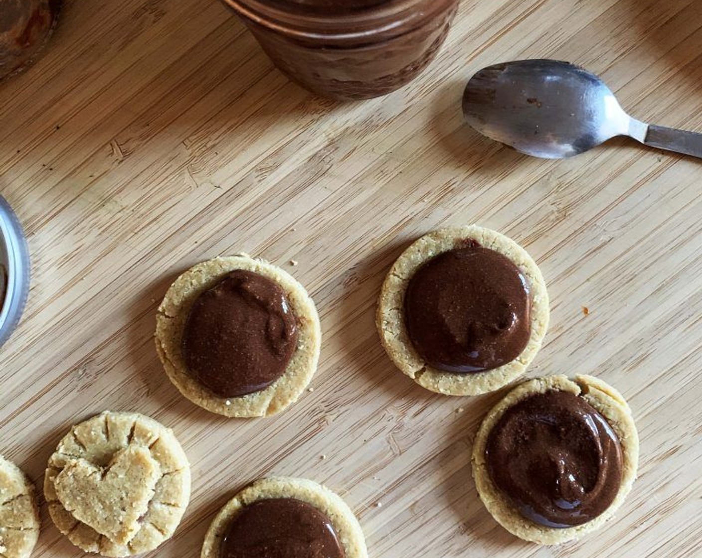 step 9 Bake the cookies in the preheated oven for 10 minutes. Remove from the oven and let cool down completely, then drop a teaspoon of Protein Hazelnut Chocolate Spread (1/4 cup) in the center of the larger rounds.