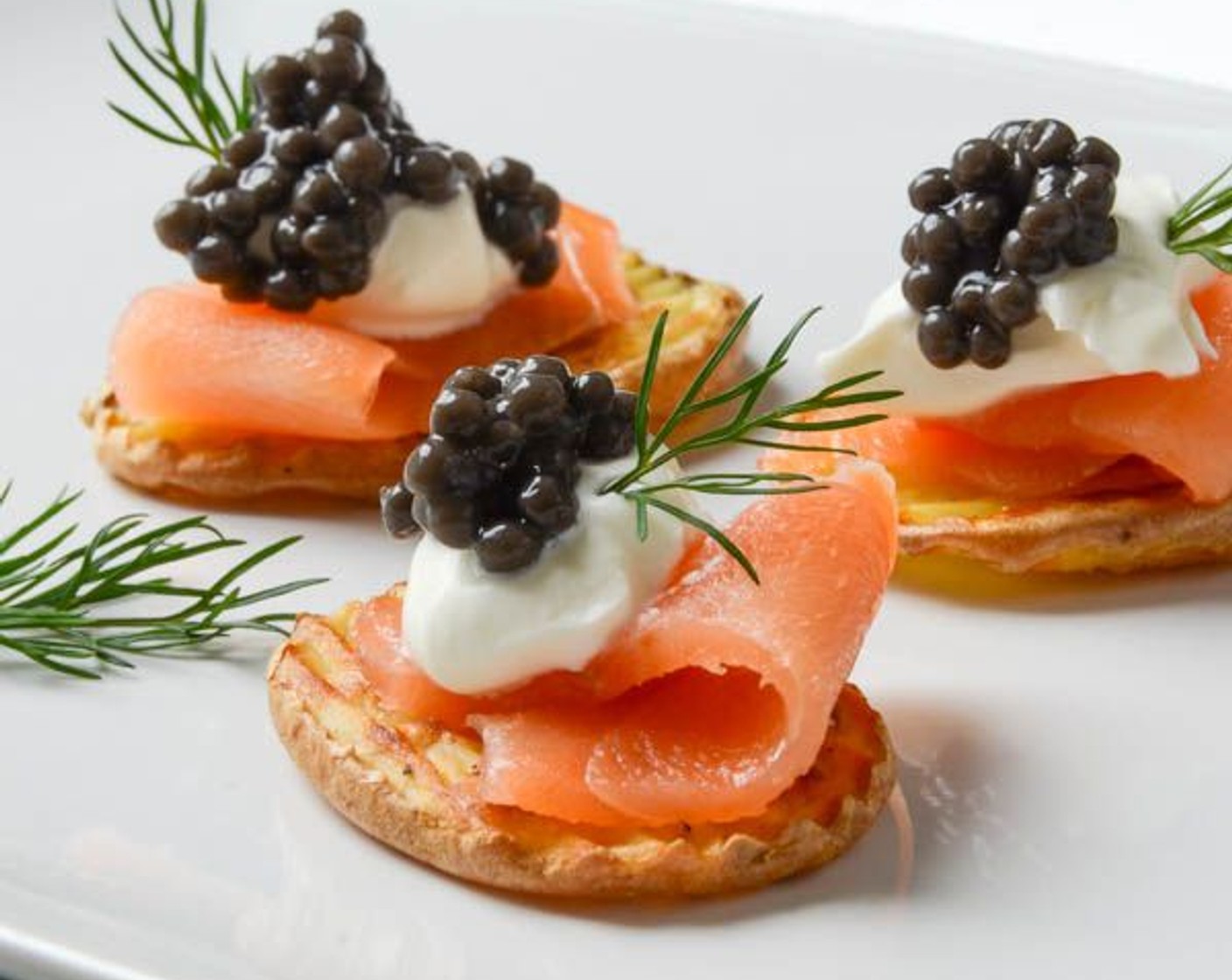 step 7 Dollop the salmon with a scant teaspoon of Crème Fraîche (1/2 cup) and about 1/4 teaspoon of Herruga Caviar (3 1/2 Tbsp). Garnish with sprigs of Fresh Dill (to taste).