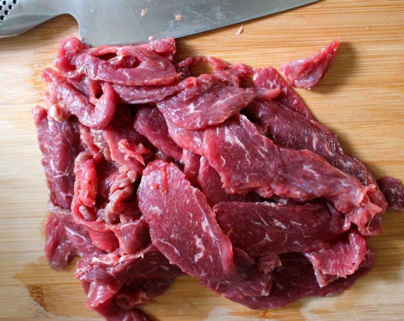 step 1 Lightly freeze, to be able to easily cut into very thin slices, Flat Iron Steak (1 lb).