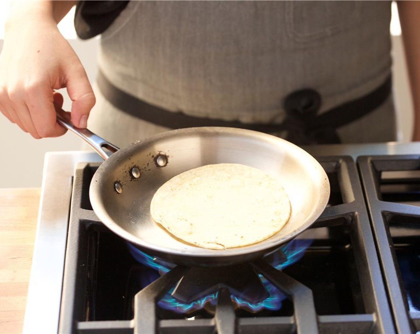 step 10 In a large saute pan over medium heat, warm White Corn Tortillas (4) for forty five seconds on each side. Stack and store tortillas in aluminum foil to keep warm.