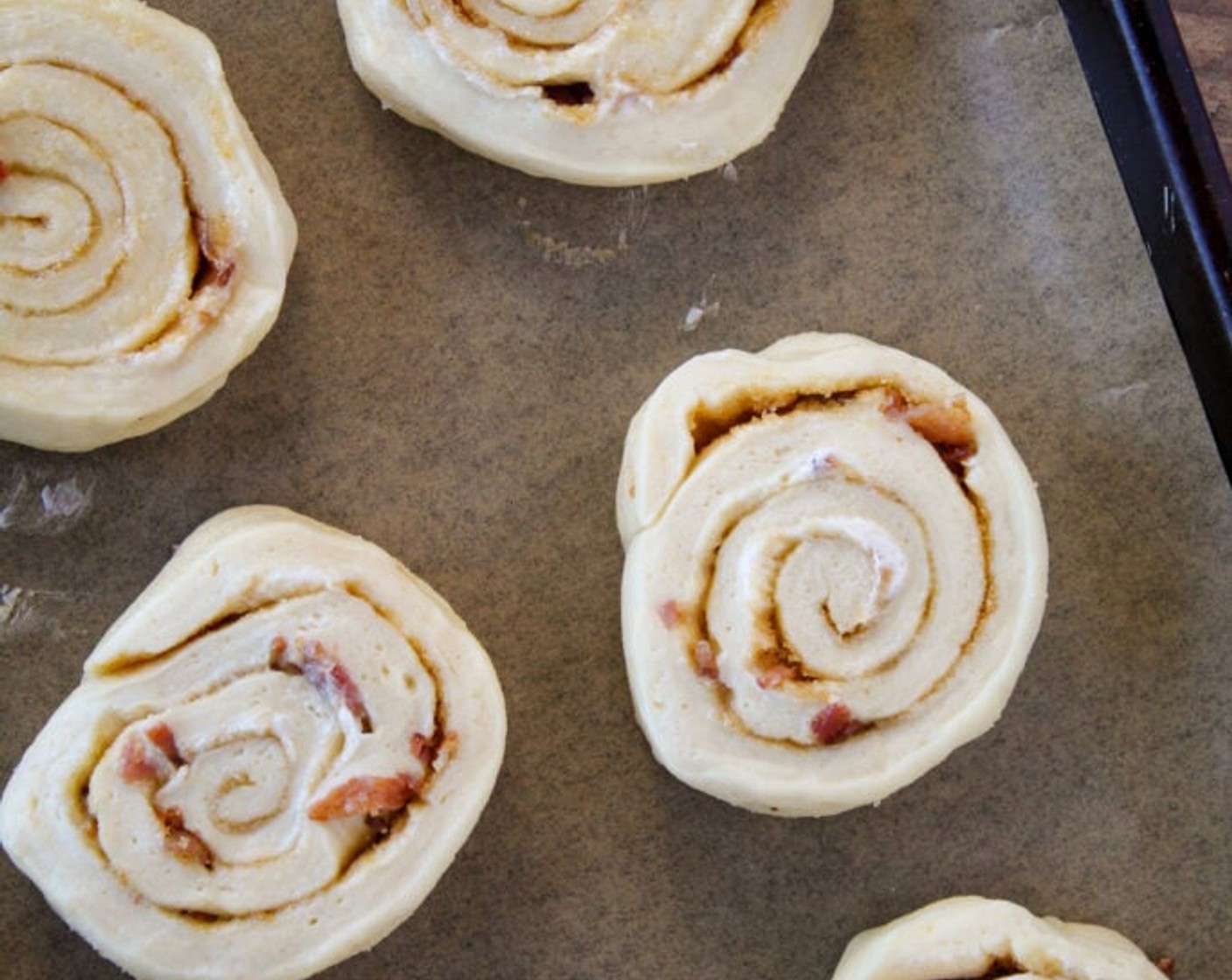 step 10 Line two baking sheets with baking mats or parchment paper and lay the cut rolls evenly spaced on the baking sheets with the cut side facing up. Cover the rolls with a towel or plastic wrap and let rise in a warm spot until doubled in size, approximately 1 hour.