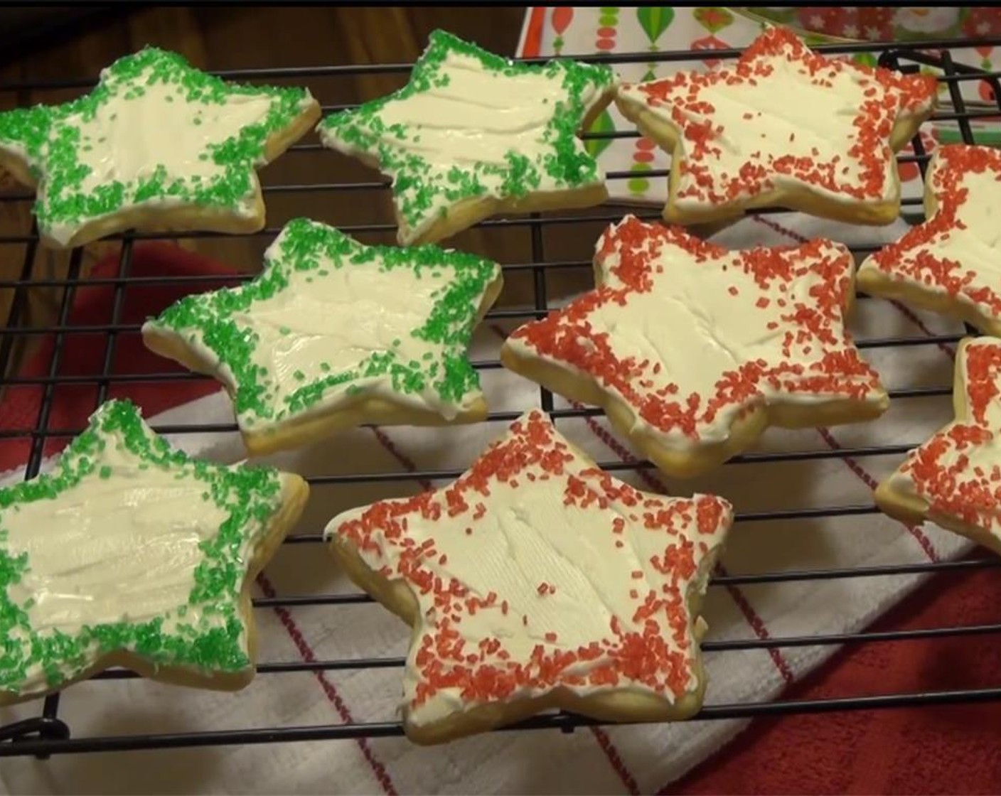 step 11 Decorate cookies with the icing. Keep a damp paper towel over the icing as you work, or it will dry up. Sprinkle them as you wish with Green and Red Colored Sugar (to taste).
