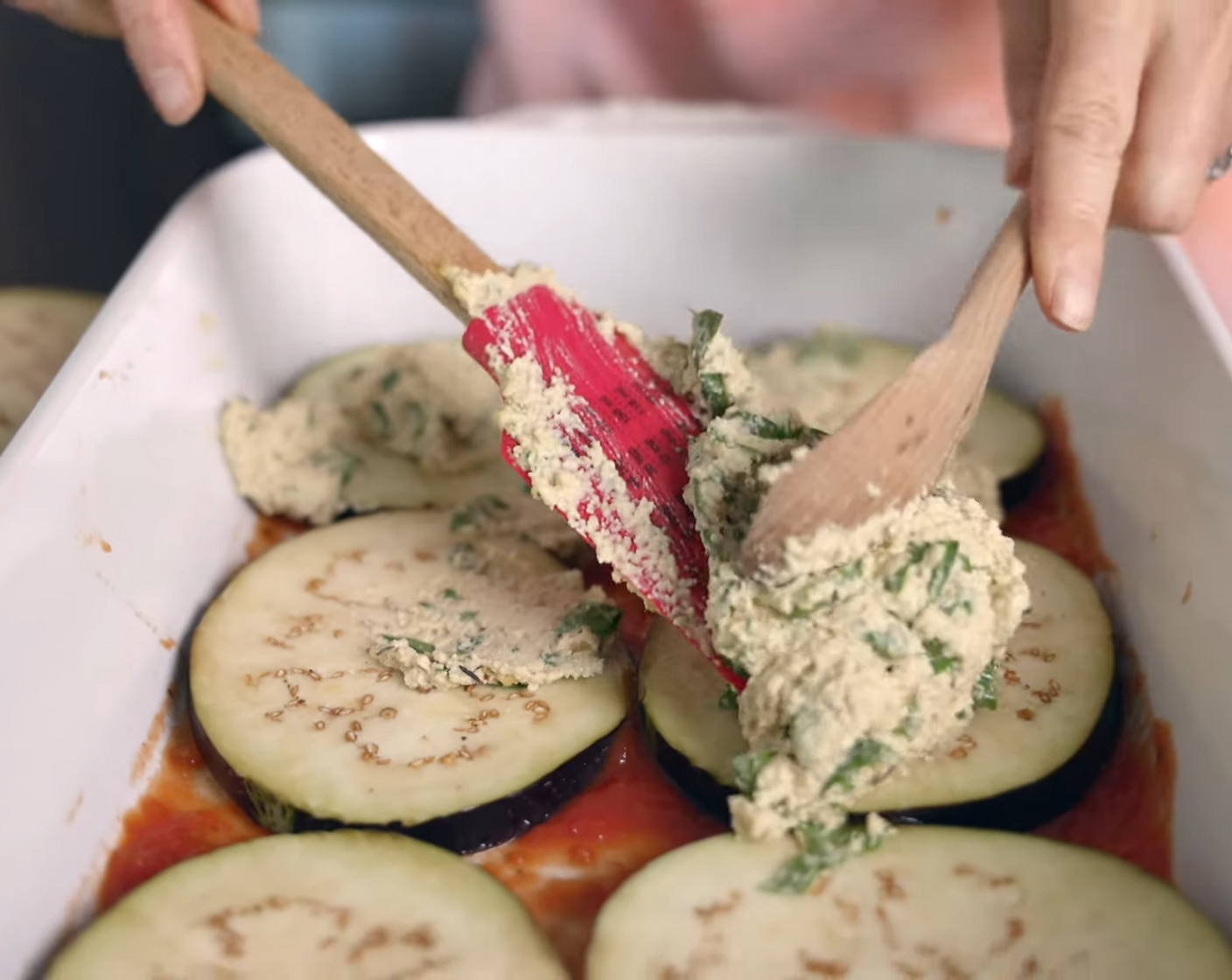 step 8 Next, add dollops of spinach cashew ricotta on top of each slice of eggplant and spread around with a spoon.