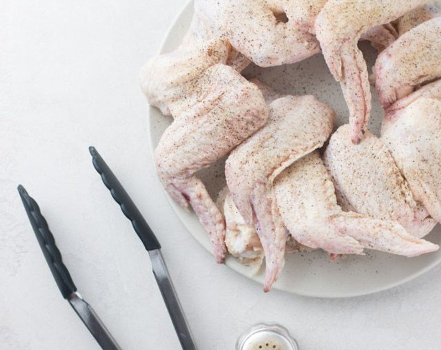 step 5 Meanwhile, generously Salt (to taste) and Ground Black Pepper (to taste) each side of the Chicken Wings (2 lb).