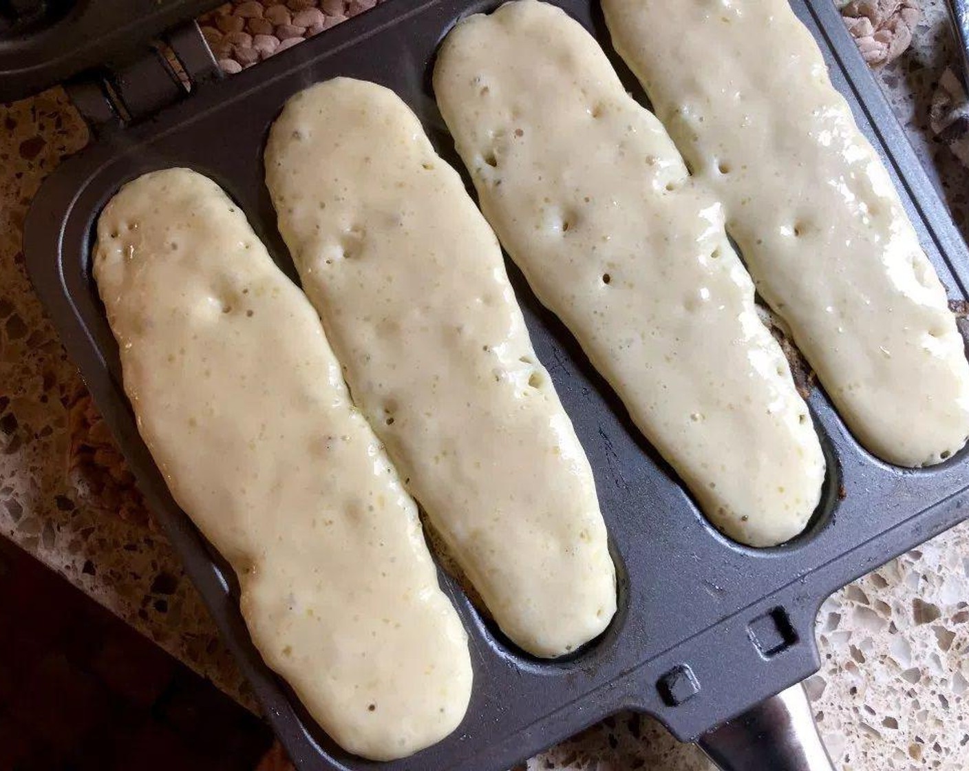 step 6 Fill the indentations of one pan just until the batter is level and attach the other preheated pan by the handy hinge. Flip the whole thing over halfway through cooking.