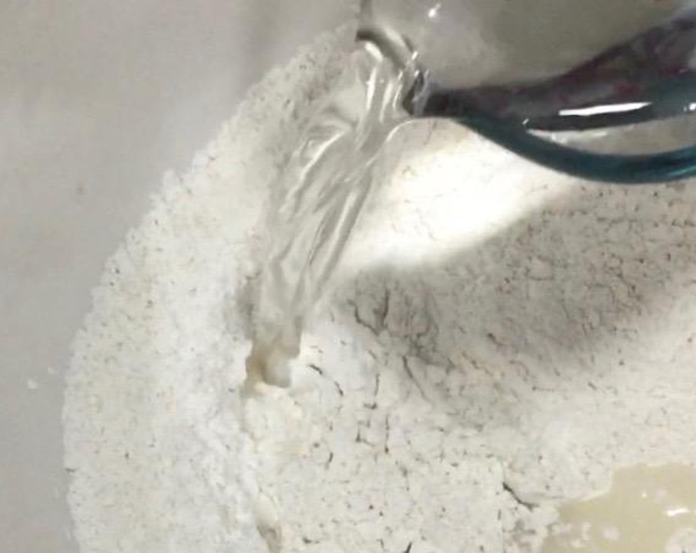 step 1 In a large mixing bowl, mix All-Purpose Flour (200 g), Instant Dry Yeast (1 Tbsp), and Granulated Sugar (140 g). Then, add in Water (180 mL) and mix well.