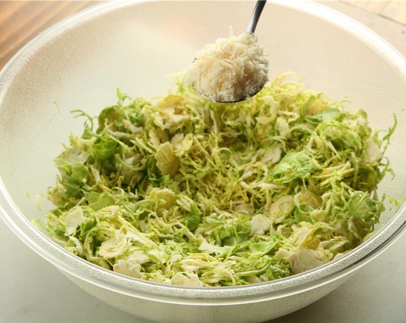 step 7 Add more Parmesan Cheese (to taste) over the shaved brussels sprouts.