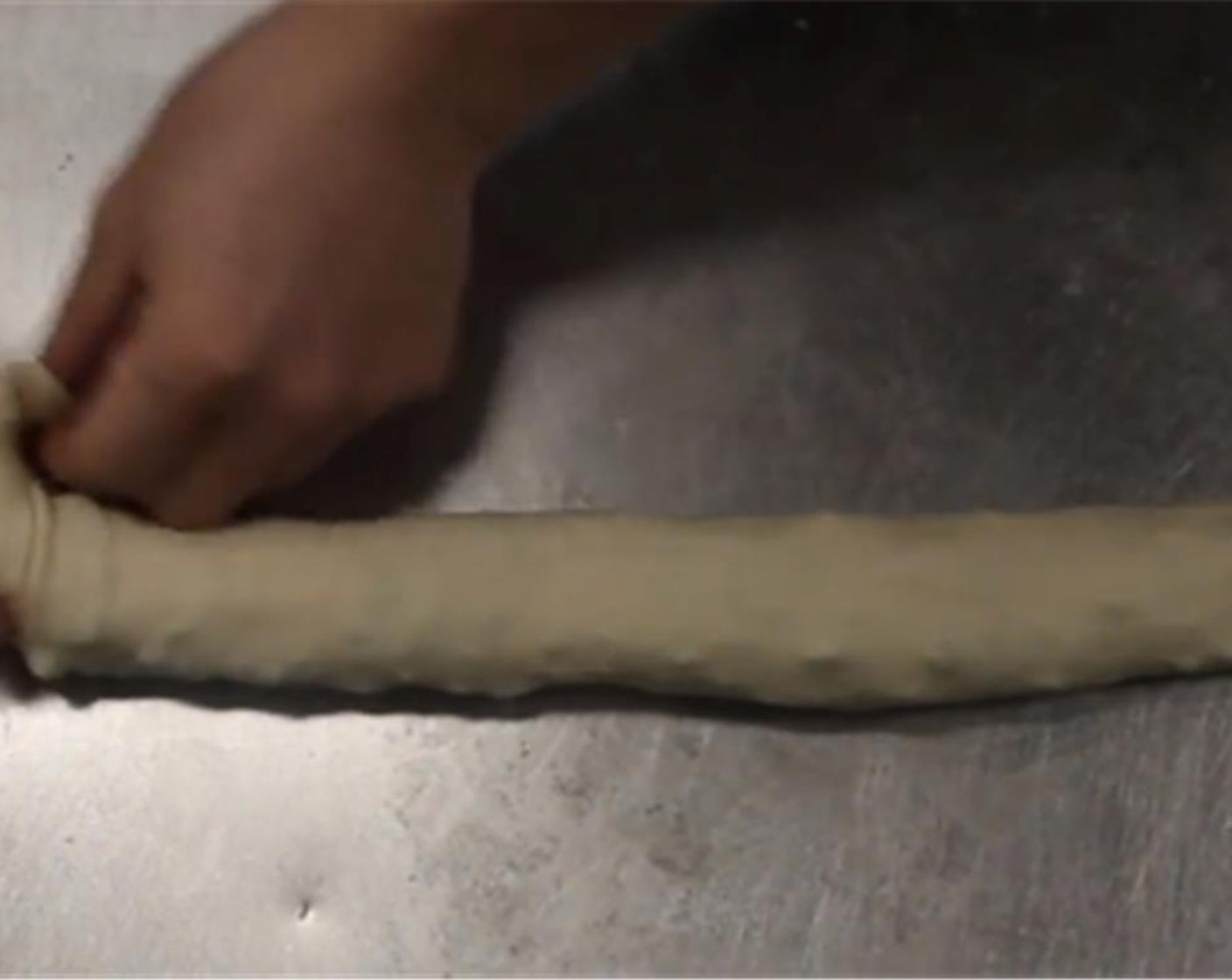 step 11 Roll the dough up lengthwise. Tuck one end of the roll into itself and begin to coil the dough.