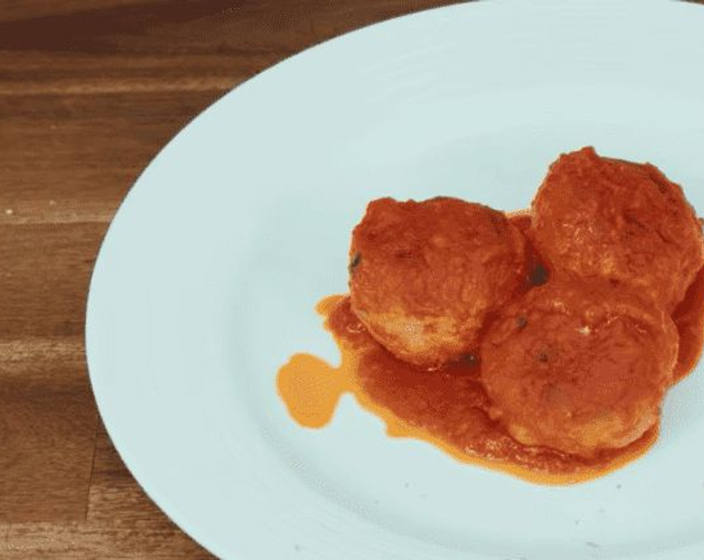 step 18 Once the meatballs are ready, place a dollop of sauce in the center of a white plate and place 2-3 on top, not to mention a generous serve of the fresh sauce on top.