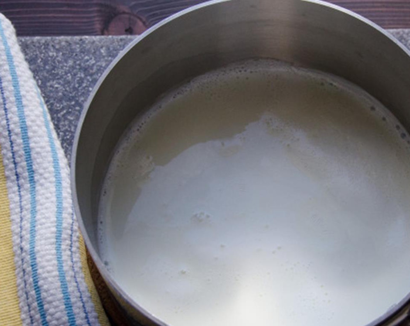 step 3 In a medium saucepan, heat the Milk (1 1/4 cups), just to boiling. With the hand mixer on a medium speed, add the milk to the egg mixture in a slow steady stream. Mix until well combined.