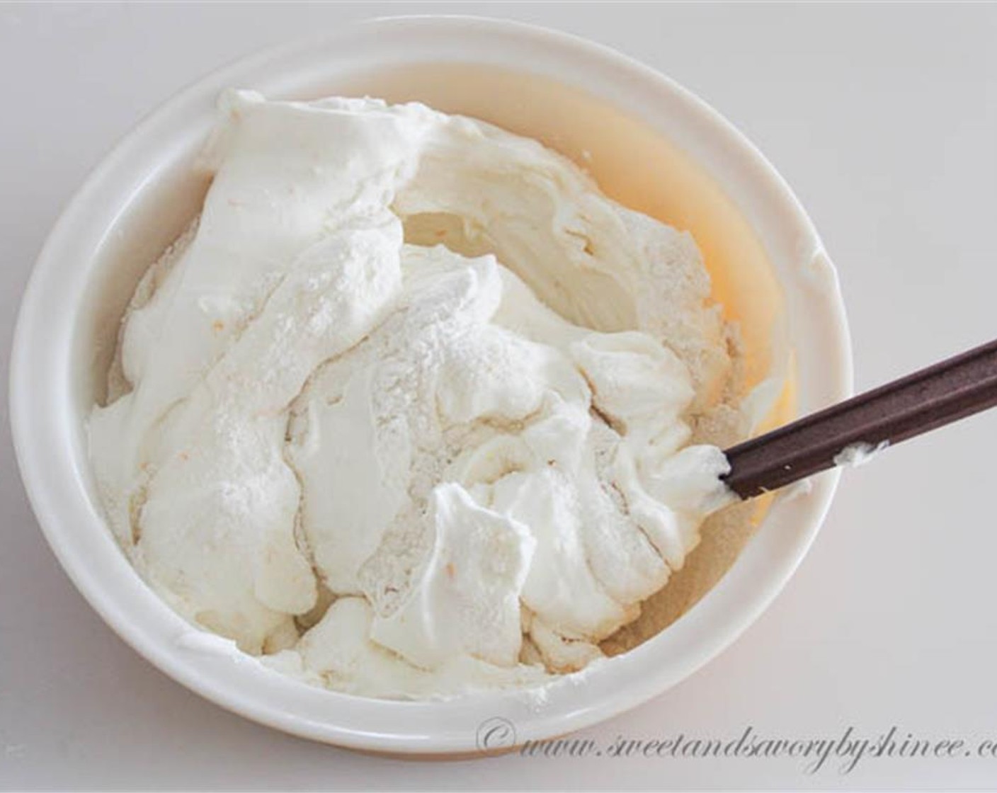 step 7 Transfer the whipped egg whites into a large bowl. Add flour/sugar mixture and carefully fold everything together. Be careful not to deflate the batter.