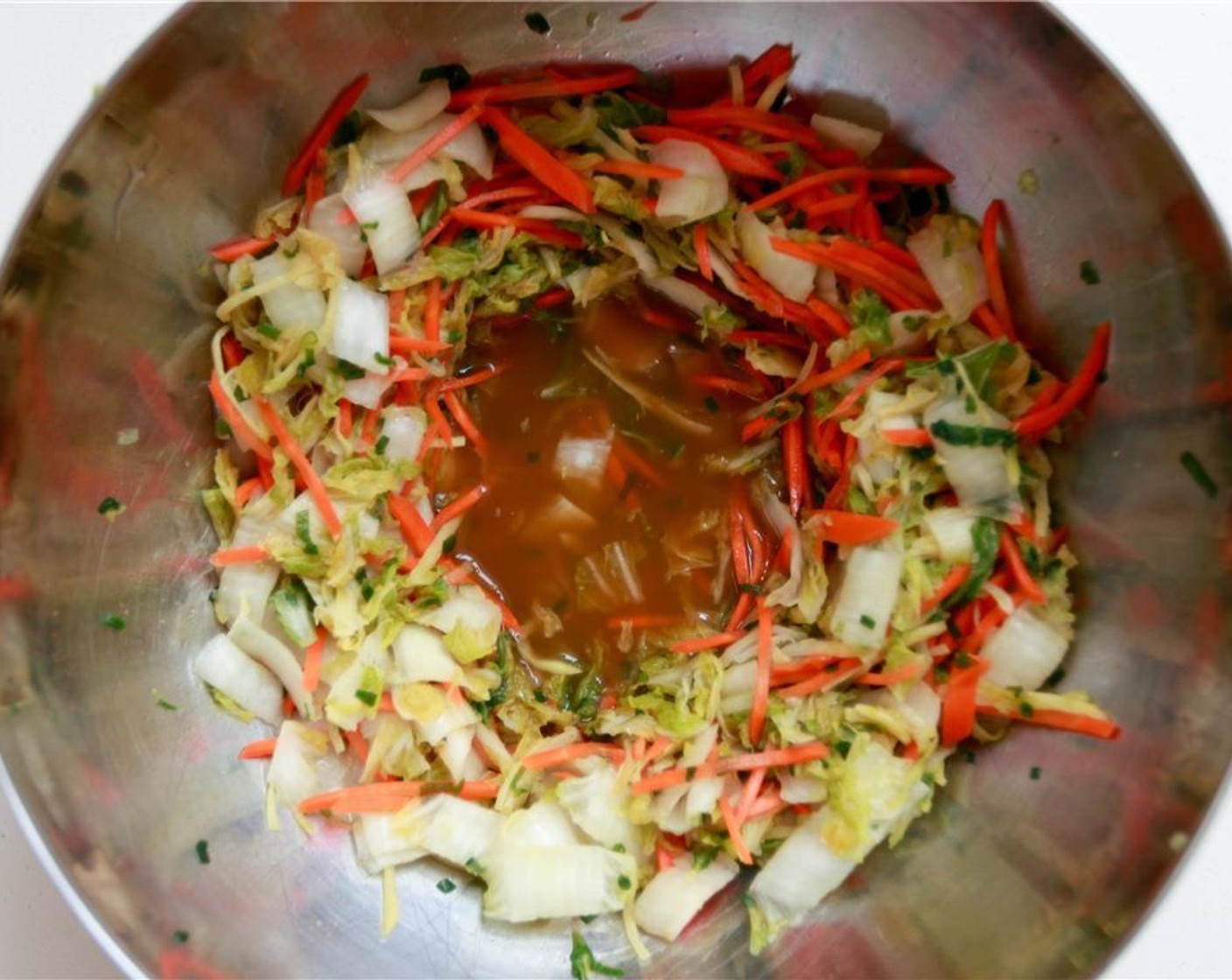 step 7 Massage and bruise the cabbage mixture with your hands for approximately five minutes to release the juices.