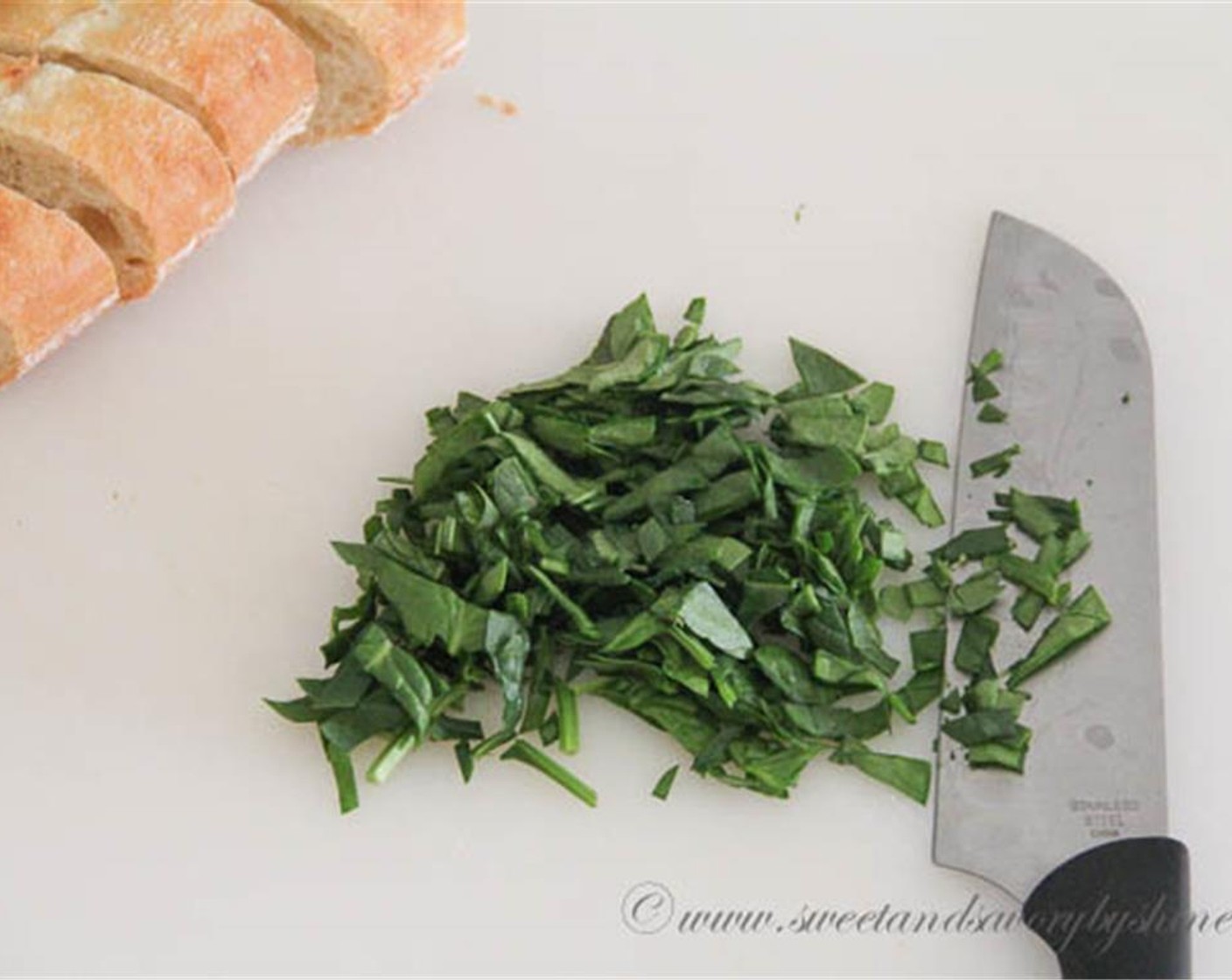 step 1 Slice the French Baguette (1/2) into 6 1-inch thick slices. Coarsely chop the Fresh Spinach (1 cup). Set aside.
