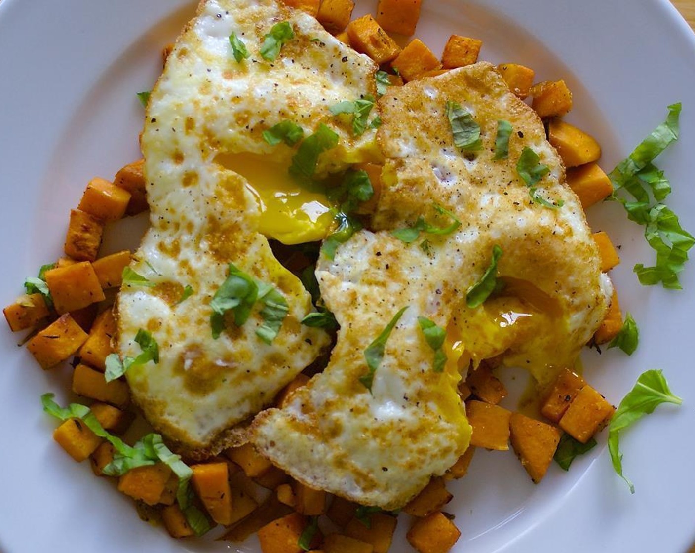 step 5 While the egg are cooking, Place the hash under the broiler for about 5 minutes until potatoes start to brown and are crispy. Spoon onto plates and top with fried eggs. Sprinkle with Fresh Basil (2 Tbsp).