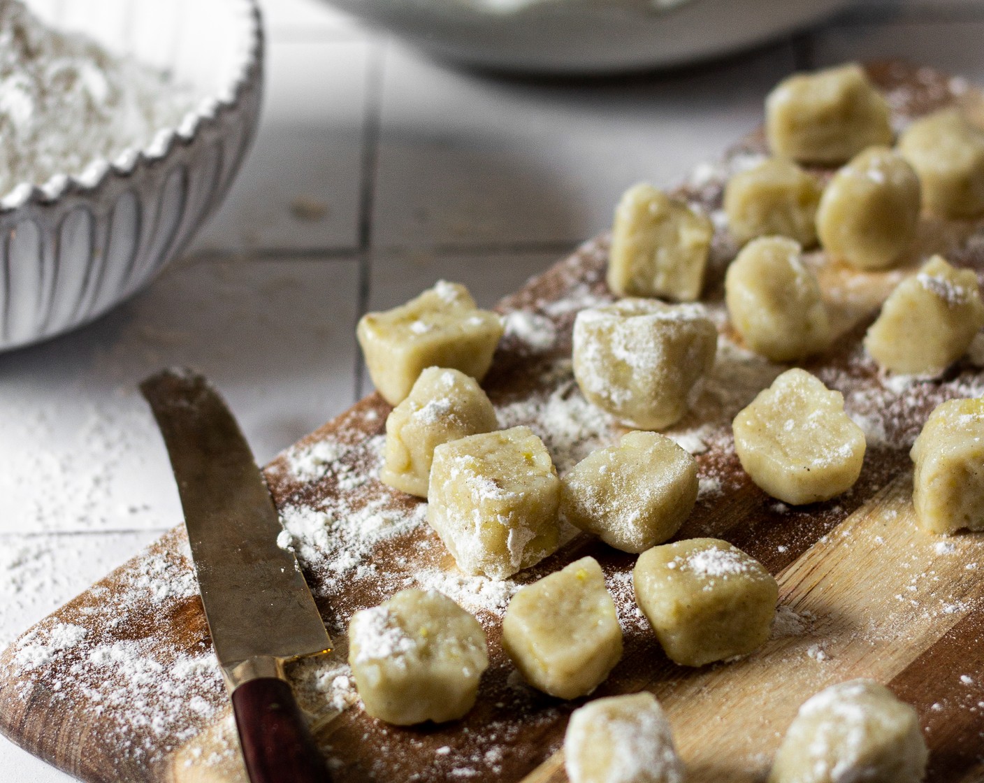 step 7 Cut dough into 1/2-inch pieces, continuing until all dough has been cut, laying each individual gnocchi out on a parchment or silicone-lined baking sheet as you work. Optional: roll each individual piece down a gnocchi board or the back of a fork for those signature grooves.