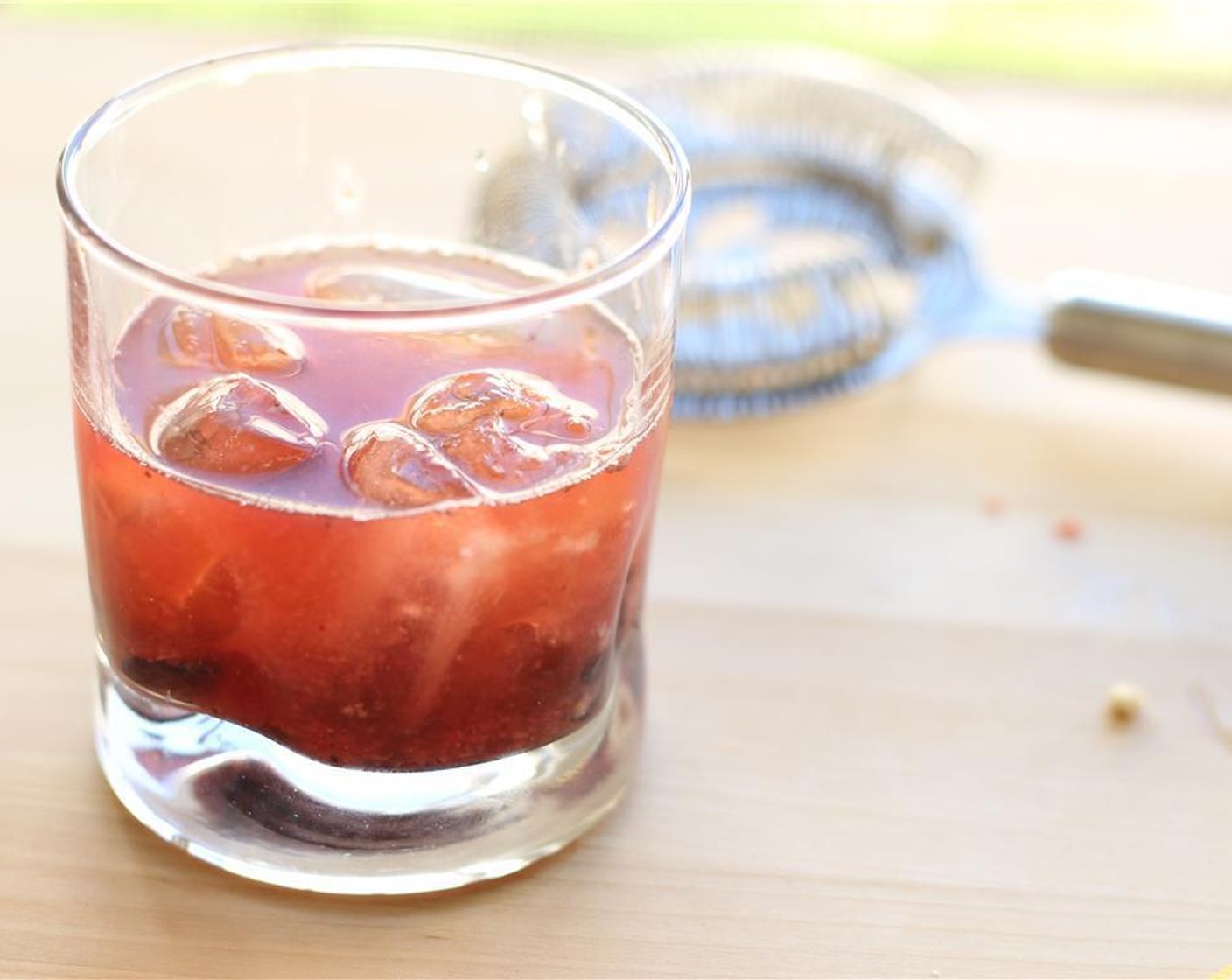 step 6 Pour chilled rum and lemon into low ball glass. Add a few pieces of ice or strain completely -- your choice!