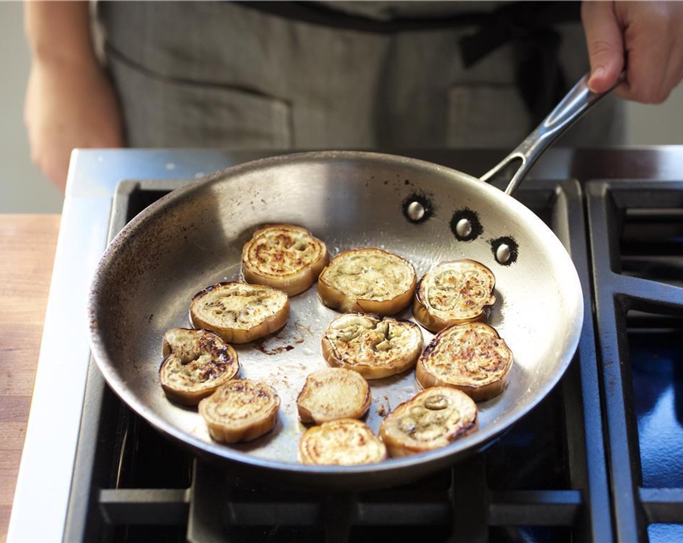 step 8 In a medium saute pan over medium high heat, add Olive Oil (1 Tbsp). When hot, add the eggplant and sear on each side for four minutes. Remove from heat and set aside.
