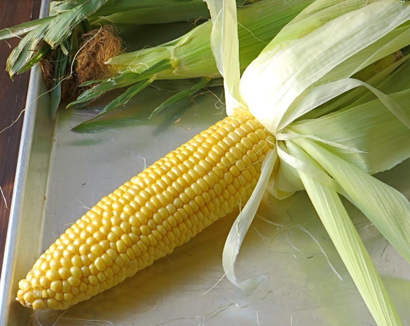 step 1 Peel the husks back from the Corn Cobs (4 ears) but leave intact. Remove the silk and discard.