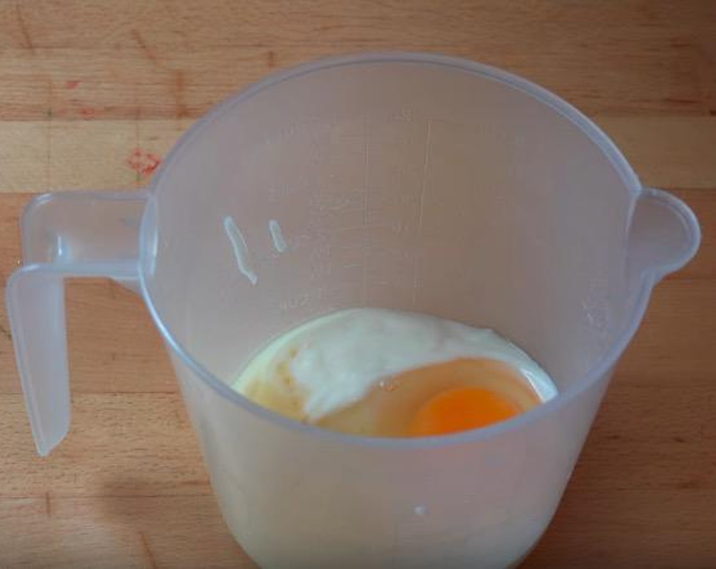 step 2 In a small mixing jug, add Vanilla Yogurt (1/2 cup), Egg (1) and Vanilla Extract (1 tsp). Mix together until completely combined.