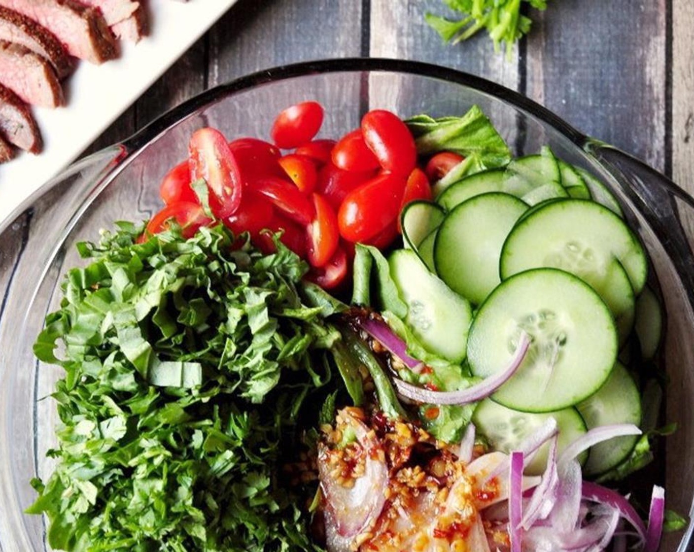 step 3 Combine the beef, Romaine Lettuce (3 cups), Cherry Tomato (1/2 cup), Fresh Cilantro (1/4 cup), Fresh Mint Leaves (1/4 cup), and Fresh Basil Leaf (1/4 cup) in a large mixing bowl.