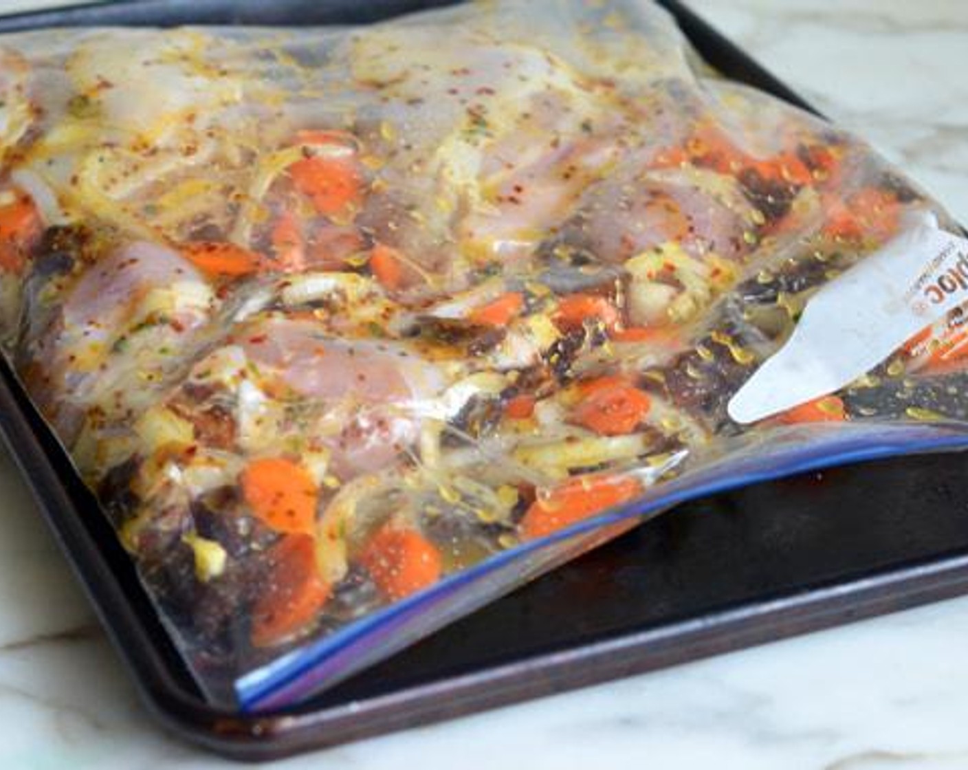 step 3 Place the Bone-In Chicken Legs (4 lb), Carrots (3 cups), Yellow Onion (1), and Dried Dates (1 cup) in a large sealable plastic bag. Add the marinade and seal shut. Massage to make sure everything is evenly coated with the marinade.