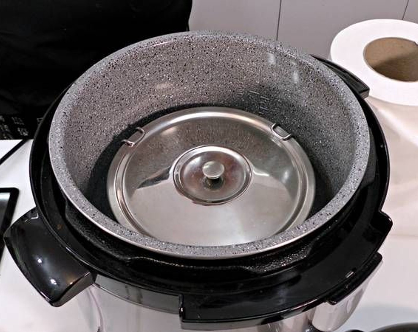 step 5 Place the lid on the metal pot and into your pressure cooker. Add enough water to cover half of the metal pot inside the cooker. Close the lid of your pressure cooker, close the valve, set it to cook for 12 minutes under "turbo" or any similar function on your cooker.