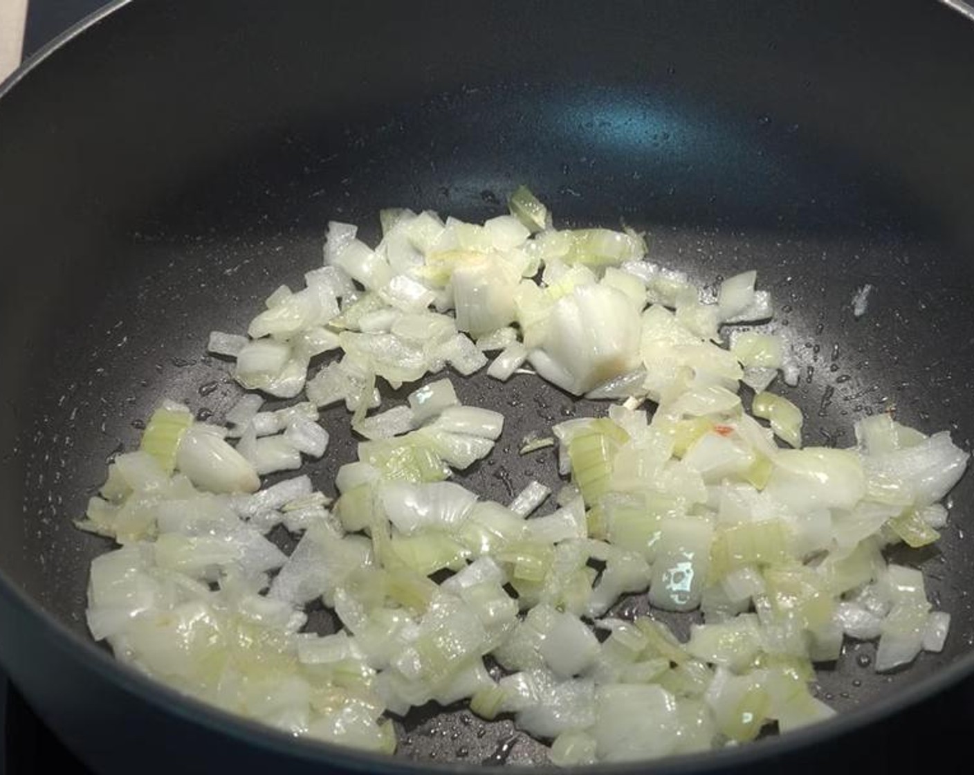 step 1 Place a little bit of Vegetable Oil (1 tsp) in a large, deep pan over low to medium heat. Add in Yellow Onion (1). Stir occasionally for about 5 minutes.