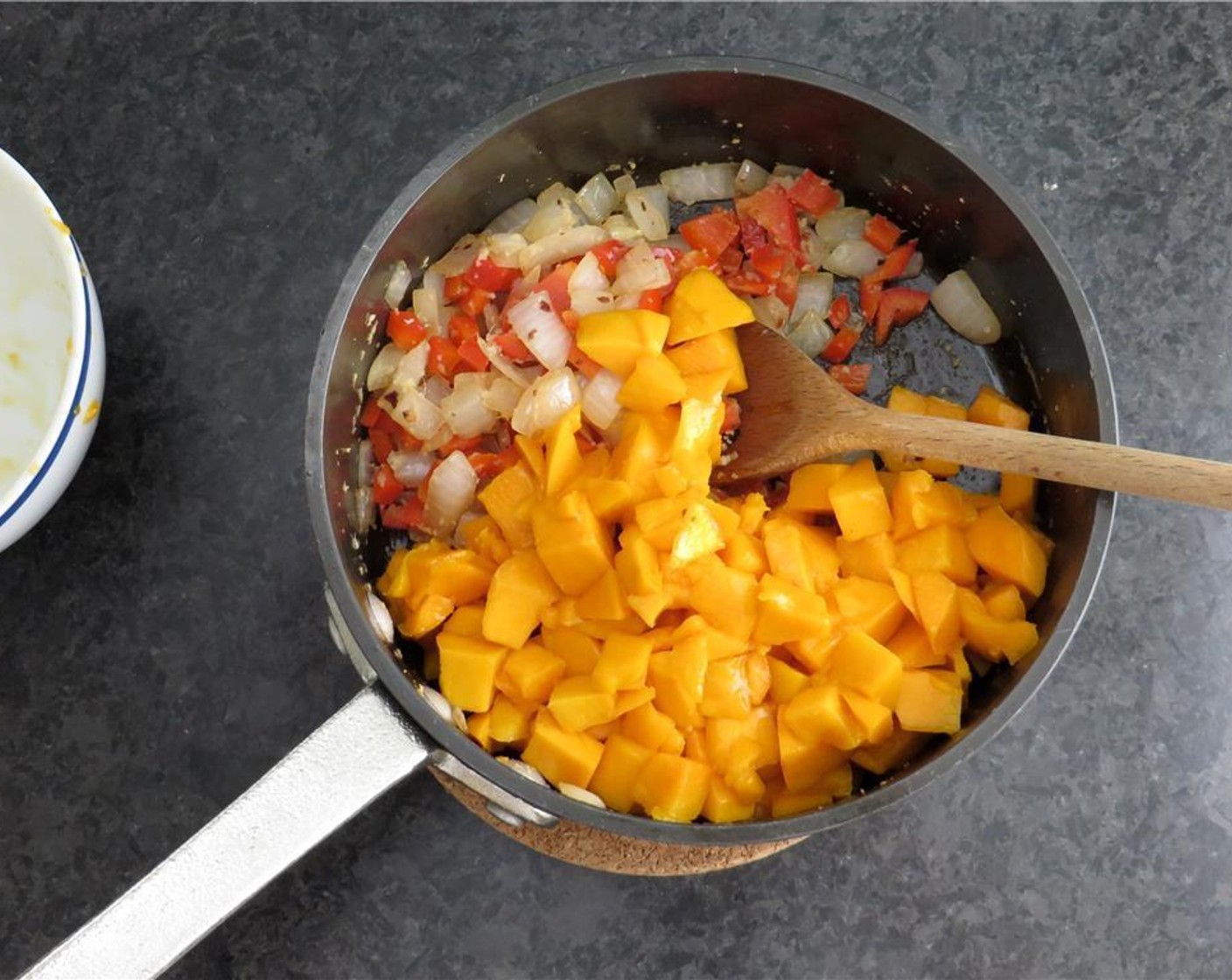 step 3 In a saute pan, heat the Vegetable Oil (1 1/2 Tbsp) and Crushed Red Pepper Flakes (1/2 tsp). Add the onions, and sweat until soft. Add the ginger and red bell pepper. Saute for 1-2 minutes. Add mangoes and cook 1 minute longer.