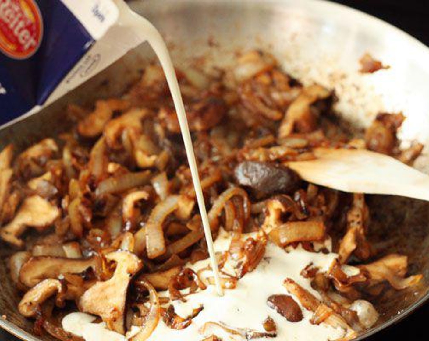 step 4 As the spaghetti cooks and the onions are mostly caramelized, move the onions to one side of the frying pan. Add the last tablespoon of Unsalted Butter (1 Tbsp) to the cleared side of the pan. Add the chopped mushrooms to the pan and sauté for 2-3 minutes.