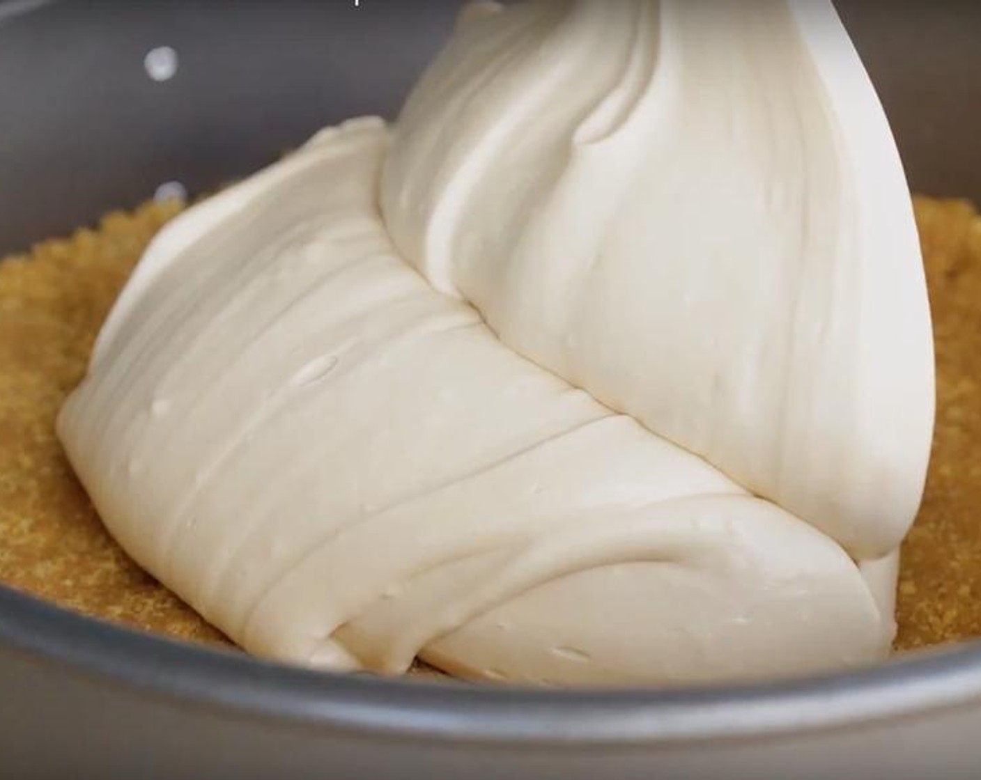 step 4 Pour batter over the prepared crust, cover with plastic wrap and fridge for a minimum of eight hours or overnight.