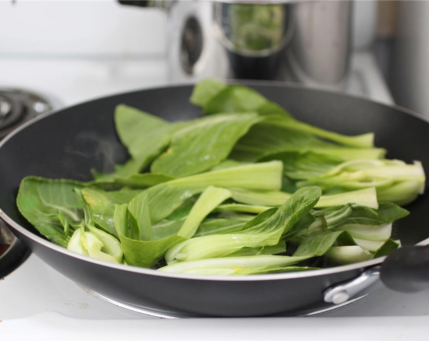 step 9 While the tofu is broiling, heat the Sesame Oil (2 tsp) in a skillet at medium to medium-high heat. Add the Baby Bok Choy (2 bunches) and sear just until the leaves are wilted – this will keep a bit of texture on the stems.