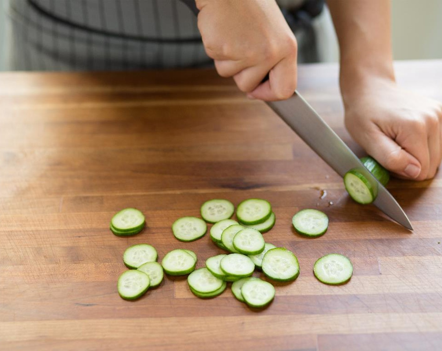 step 4 Slice the Mini Cucumber (1) into rounds; set aside.
