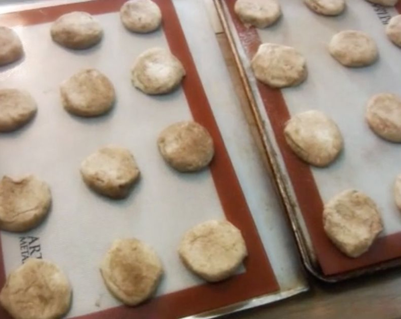 step 6 Shape the dough into balls and roll them in Cinnamon Sugar (to taste) to coat. Transfer cookies to a baking sheet and press down to flatten them out slightly.