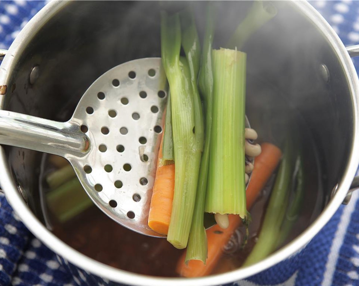 step 9 Once the veggies are cooked to desired doneness, remove from the liquid and set aside, and discard the thyme.