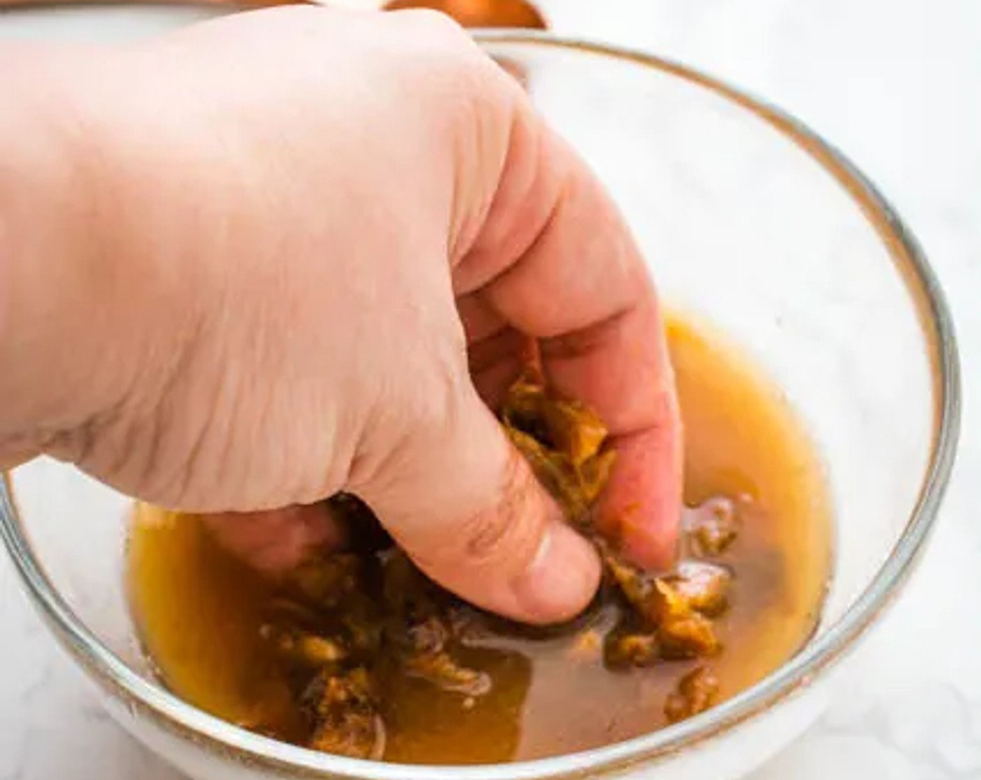 step 3 Gently squeeze the tamarind paste with your fingers to extract as much of the juice as possible. Discard the tamarind paste and seeds (if any).