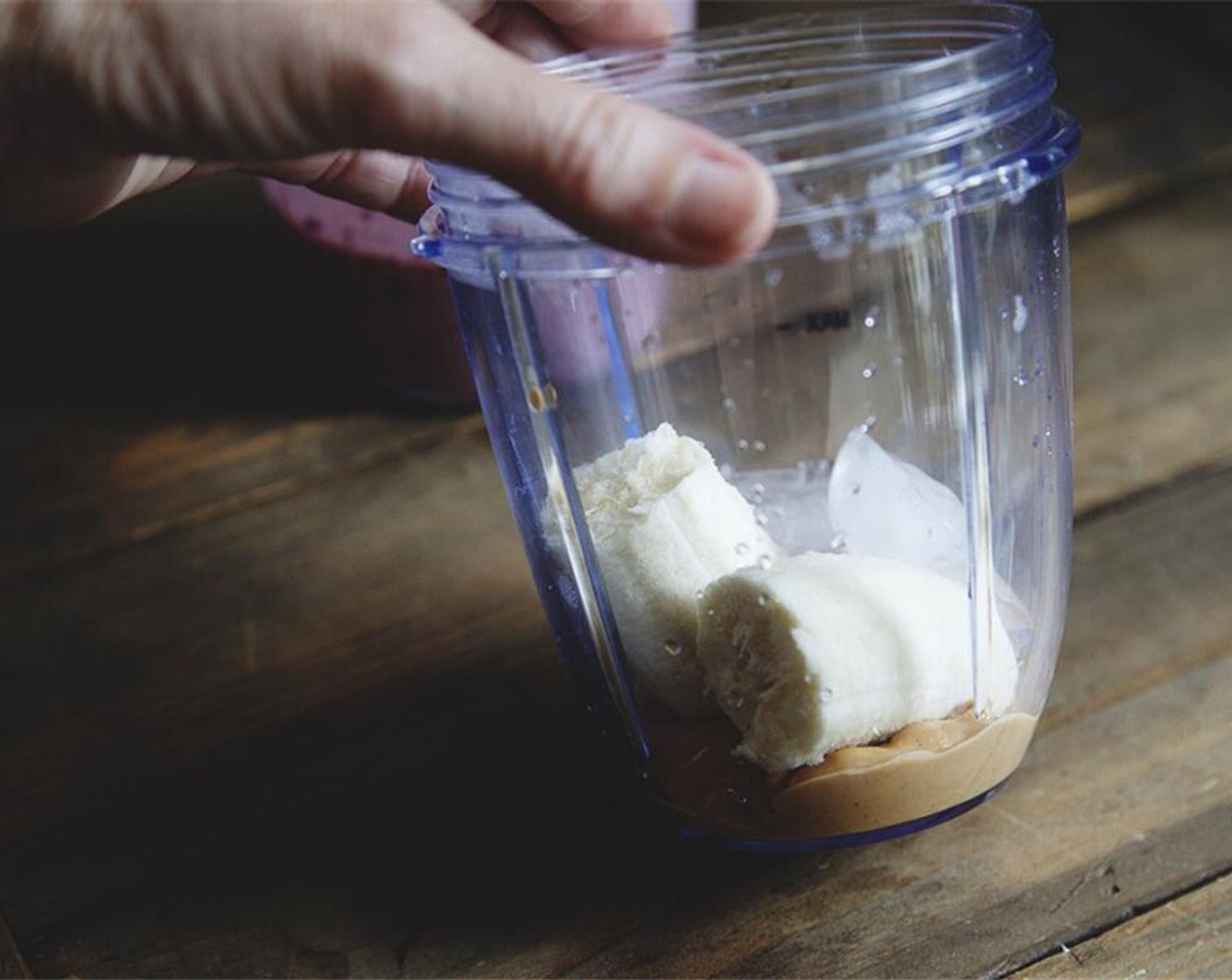 step 4 In the clean blender, add Peanut Butter Protein Powder (2/3 cup), the rest of the banana, and Ice (3) cubes. Blend until smooth.