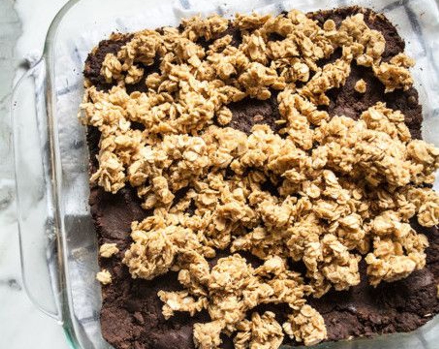 step 7 Add remaining oat mixture on top of filling and spread evenly, then press down to create the final top layer. Refrigerate for 15-20 minutes or until top layer has hardened.