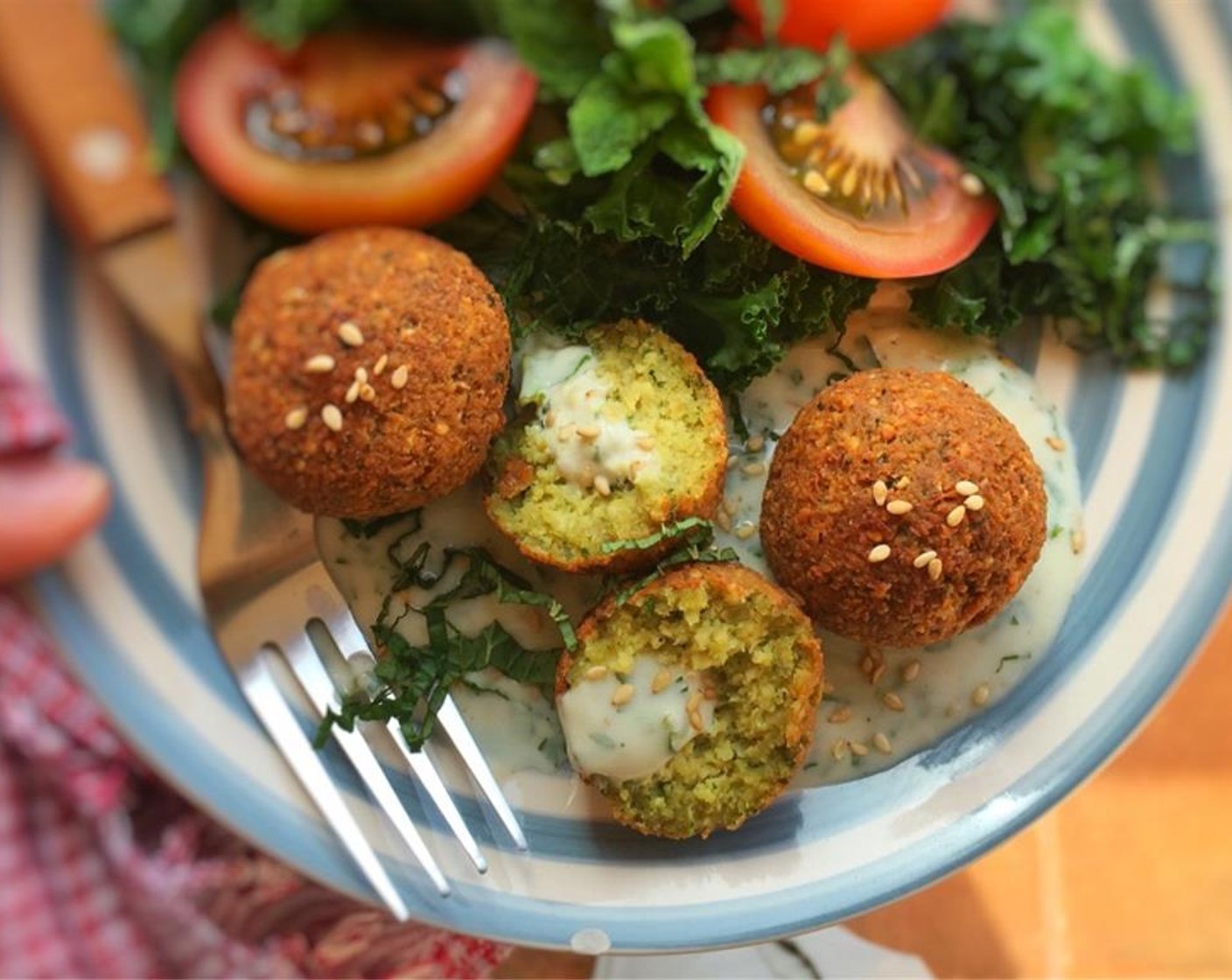 step 11 Serve the falafels with a dipping sauce of your choice (hummus, pesto, my sesame yogurt falafel sauce, even tartar sauce), some fresh lettuce, cucumber, tomato or tabbouleh or stuff it altogether in a warm pita bread.