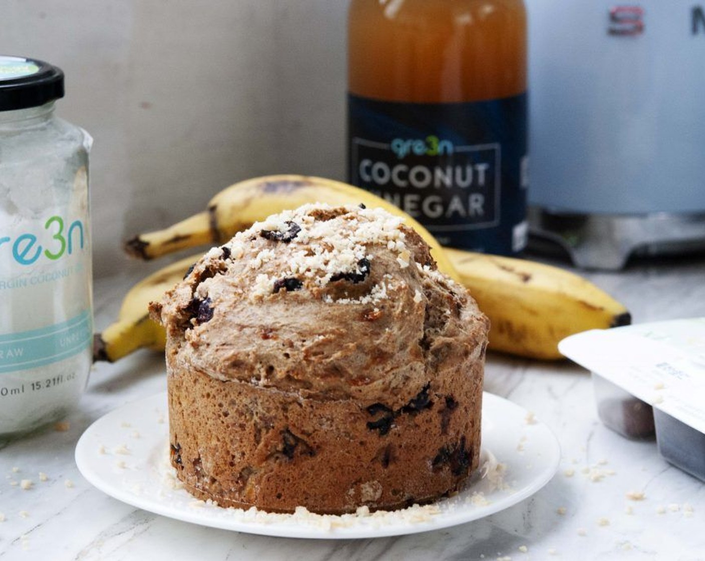 step 8 For the topping, smash the Coconut Chips (2 Tbsp) using a rolling pin, until they've turned into powder and sprinkle it on top. Slice it up and enjoy it with a nice cup of coffee or tea!