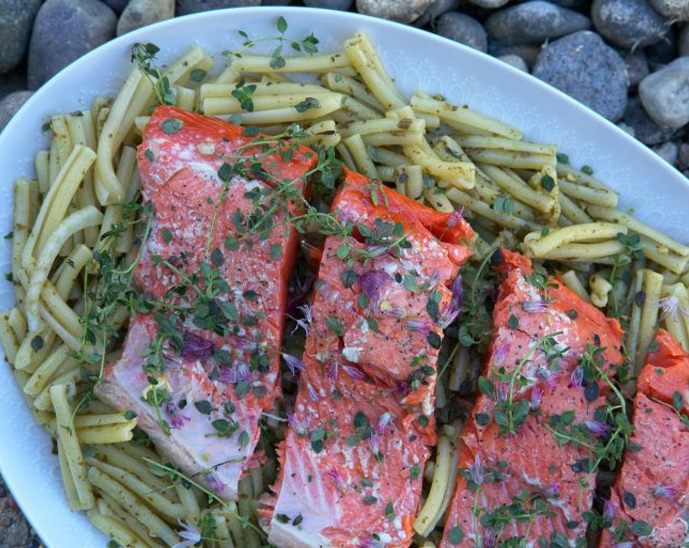 step 10 Drain your pasta and mix well with the pesto. Add to your serving platter. Top with the cooked salmon. Serve immediately. Enjoy!