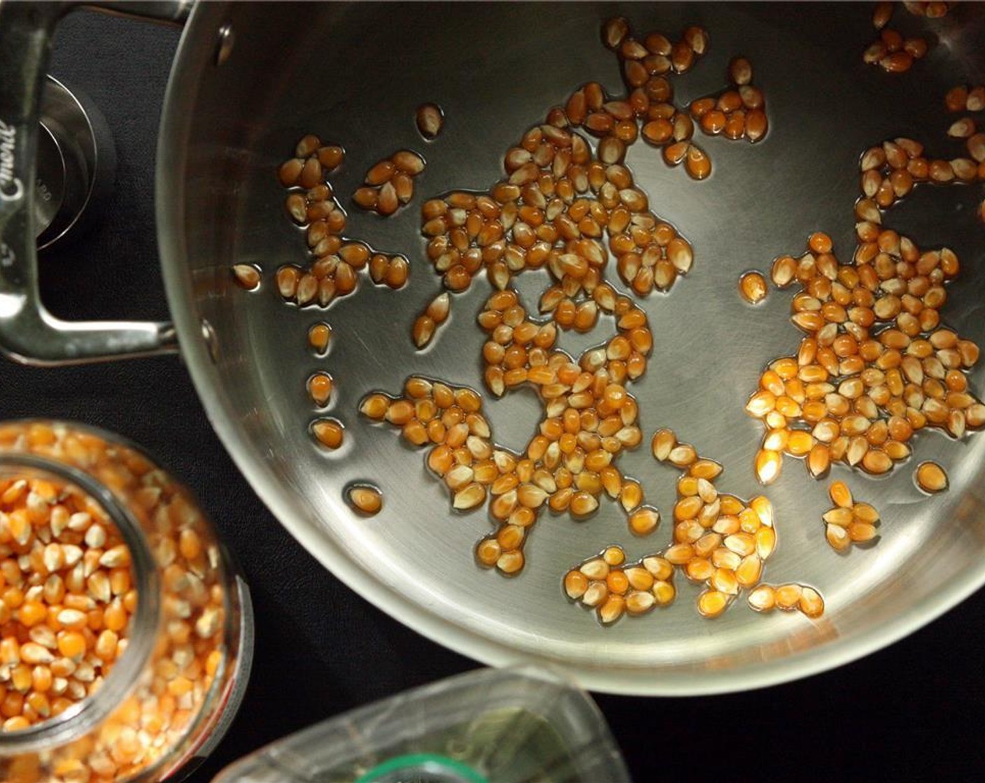 step 2 Add the kernels and Canola Oil (2 Tbsp) to the pot and tilt the pot back and forth to coat the kernels.